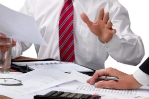 Two men in ties working the paperwork