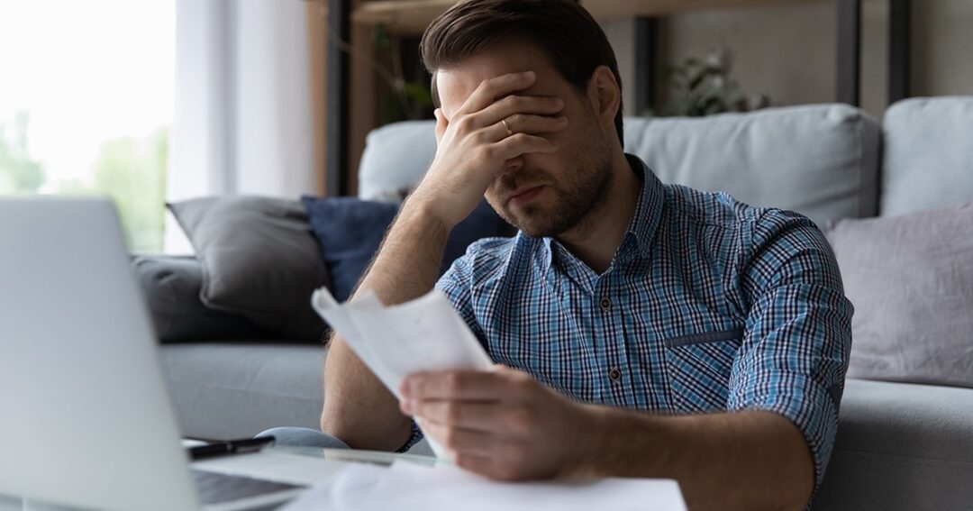 Upset man holding his head with his hand